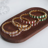 Celestia 18K gold gemstone bracelet with zircon inlays on white background